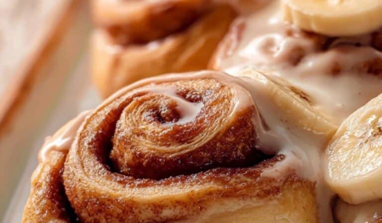 Banana Cinnamon Rolls with sliced bananas and vanilla glaze
