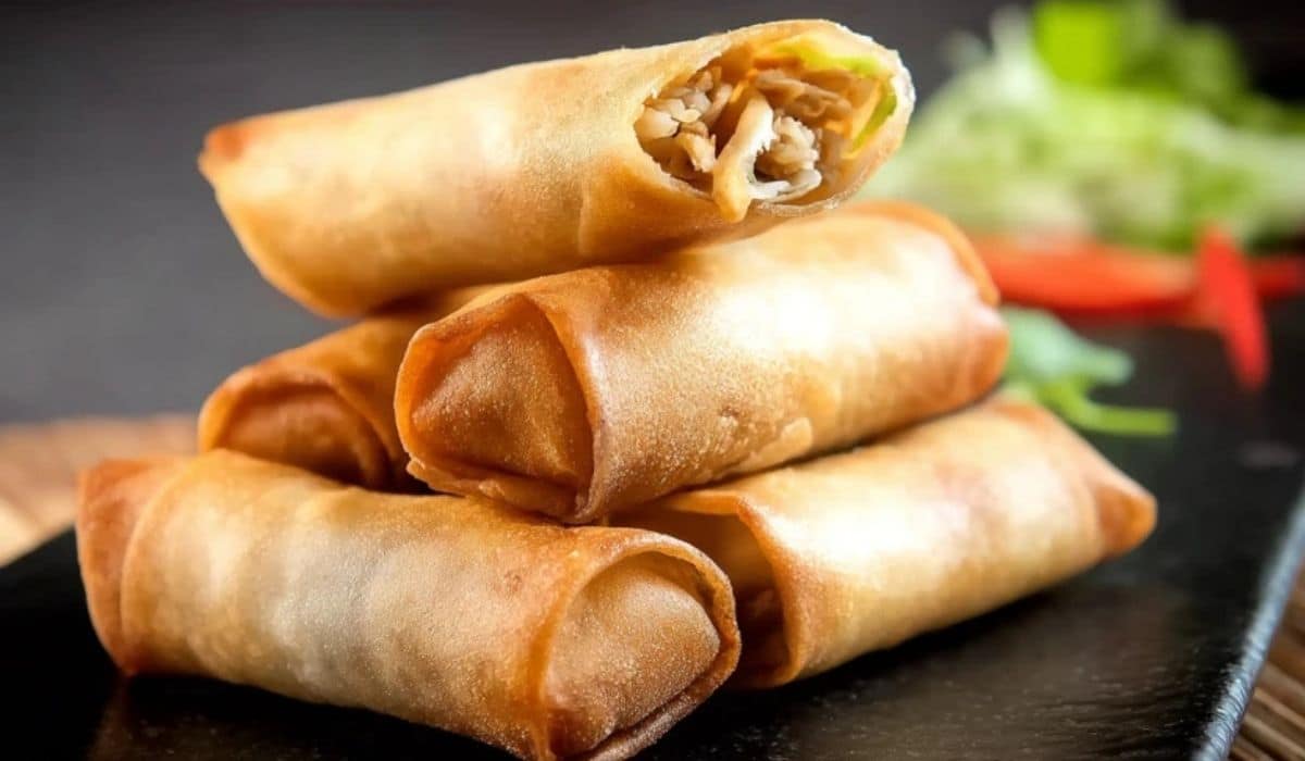 Crispy Chicken Spring Rolls stacked on a black plate