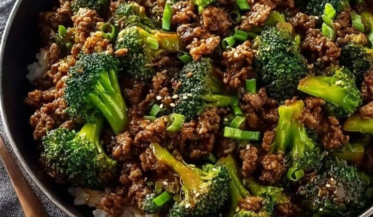 Ground Beef and Broccoli Stir Fry served over white rice in a black skillet