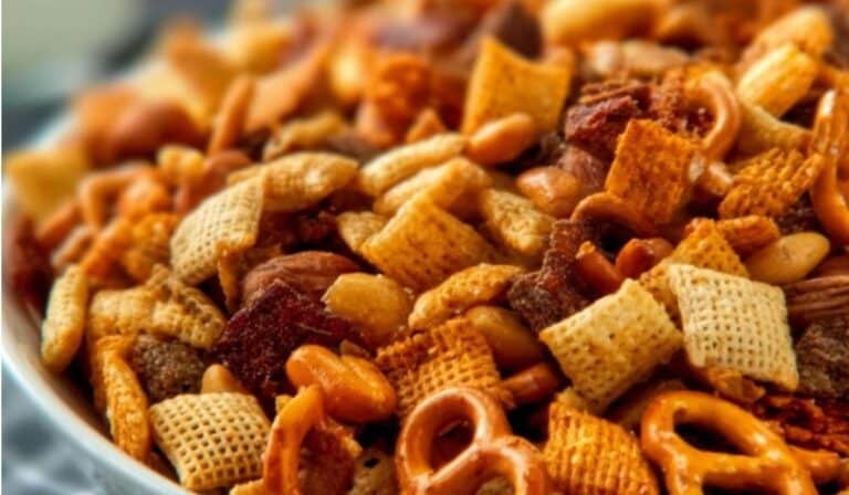 Party Snack Mix close-up with cereal, pretzels, nuts, and seasoning