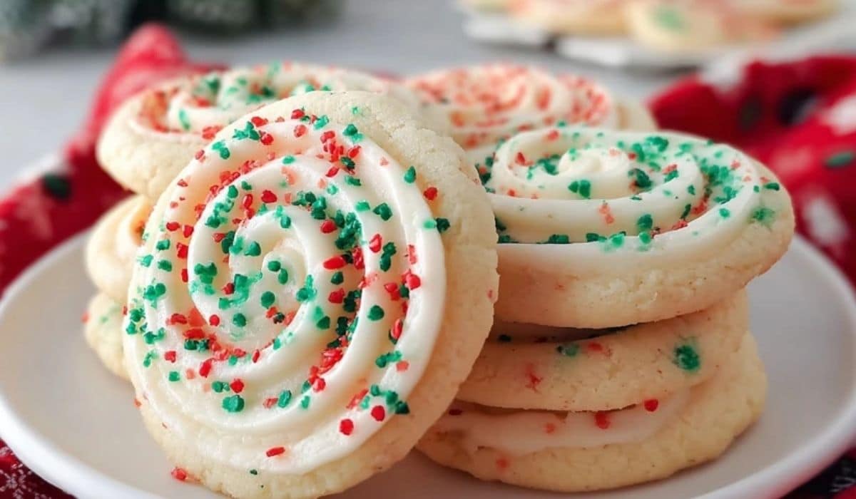 Crumbl Christmas Sugar Cookies stacked on a festive holiday plate with red and green sprinkles