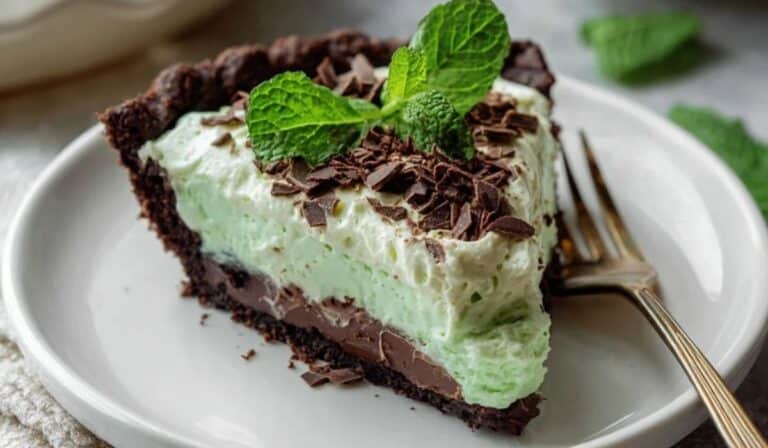 Mint chocolate cake served elegantly with ganache and mint leaves