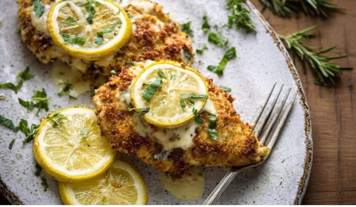 Lemon Chicken Romano served on white plate with lemon garnish