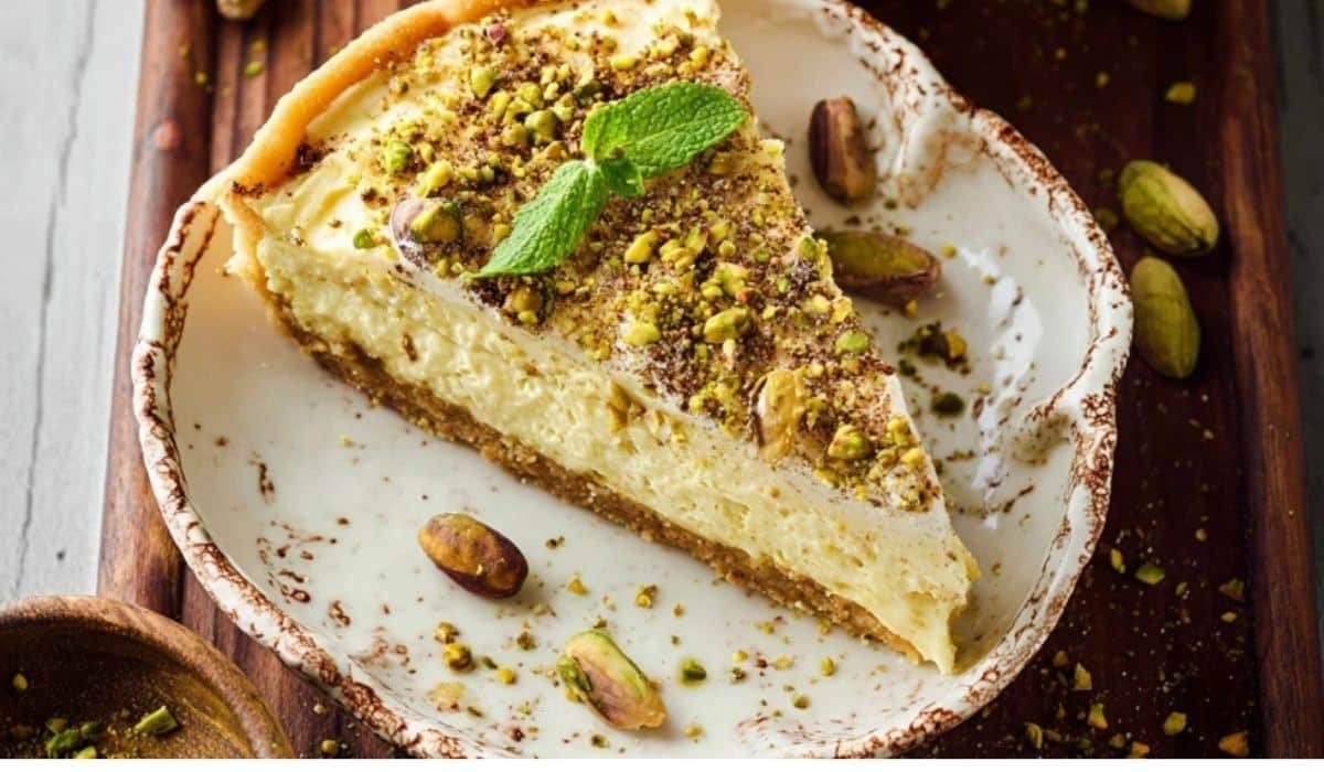 Baked Pistachio Custard Pie sliced on wooden table with rustic serving style