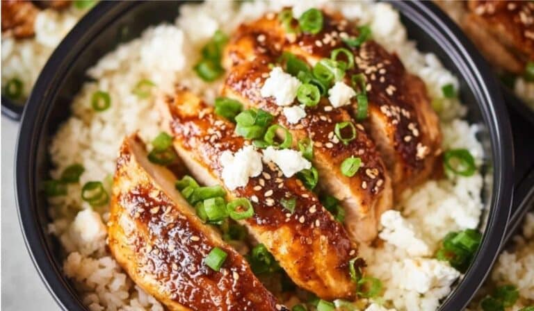 Chicken and rice meal prep bowls arranged in glass containers with vegetables