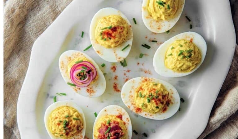 Classic deviled eggs 3 ways on a serving platter with three toppings