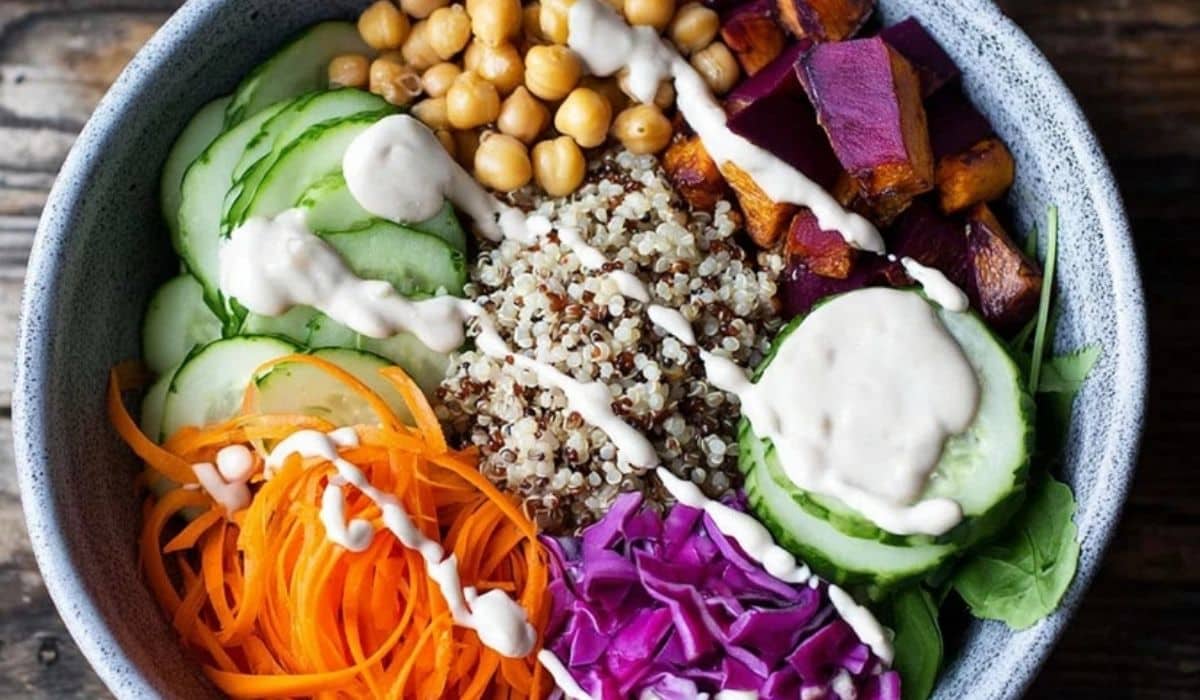 Rainbow grain bowl with tahini topped with colorful roasted vegetables