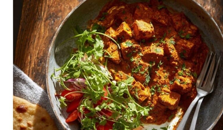 Crispy tofu tikka masala in a bowl with rice and naan