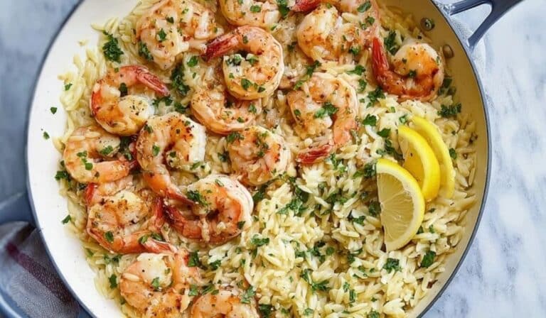 Garlic shrimp orzo in a skillet with lemon, spinach, and Parmesan
