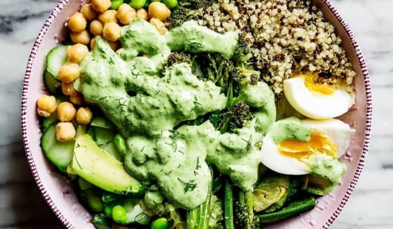 Green goddess grain bowl with quinoa, chickpeas, avocado, and creamy herb dressing