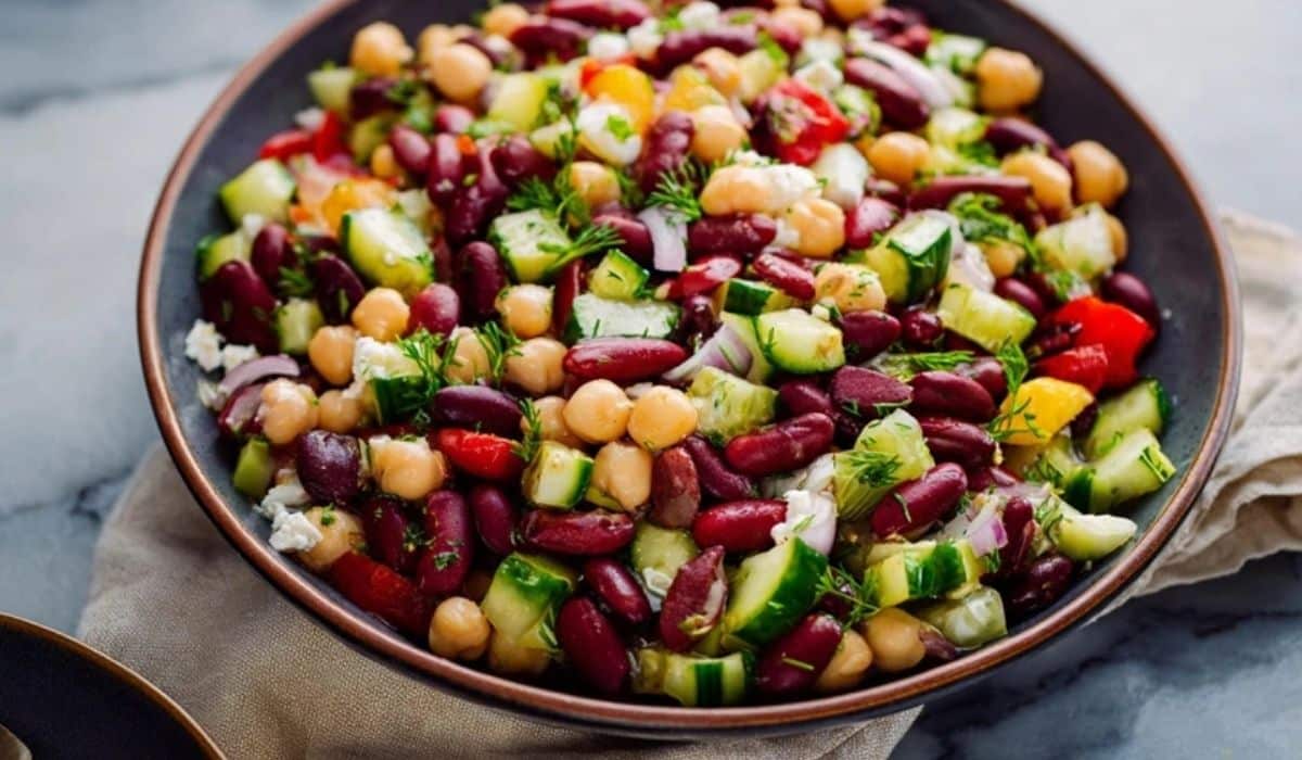 Mediterranean chickpea bowl with quinoa, vegetables, feta, and tahini drizzle