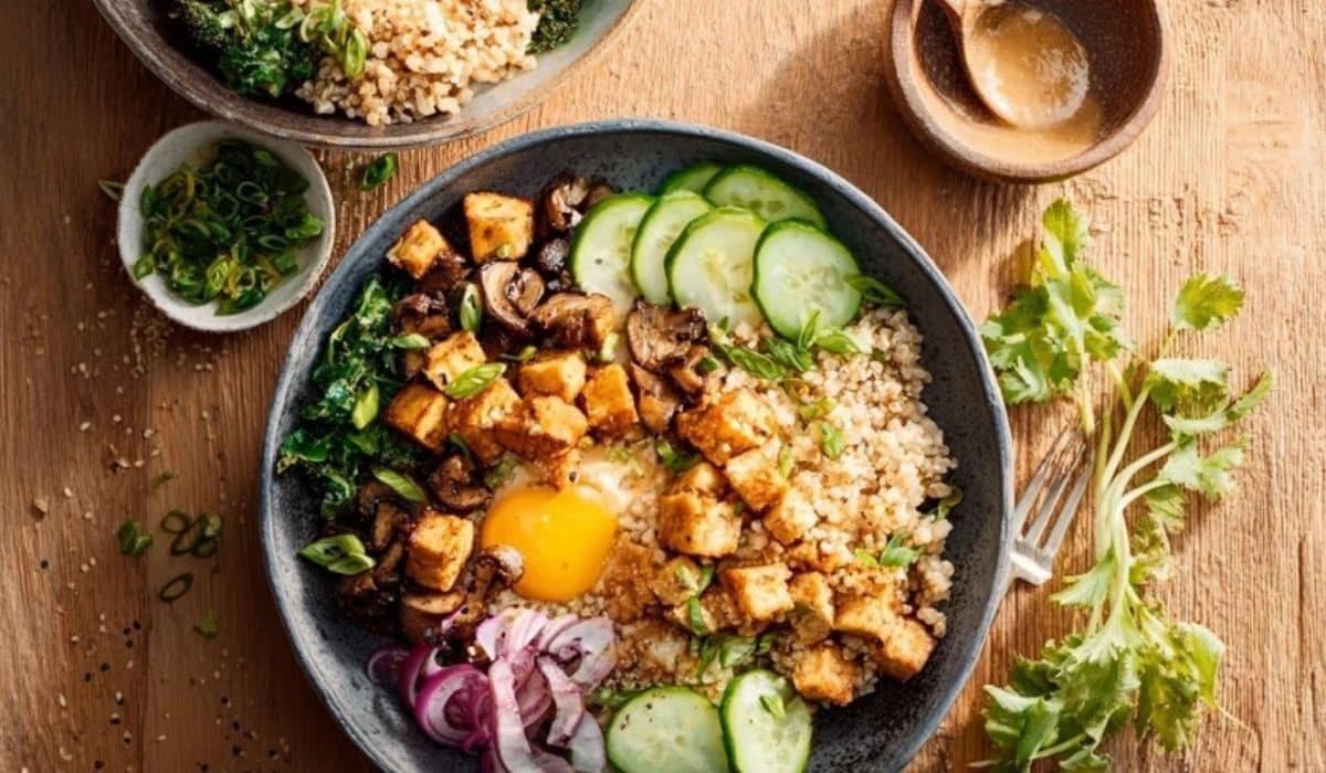 Vegan protein grain bowl with quinoa, lentils, edamame, and tahini drizzle